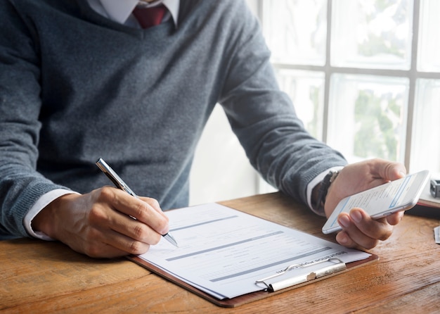 Premium Photo | Man writing insurance application form concept