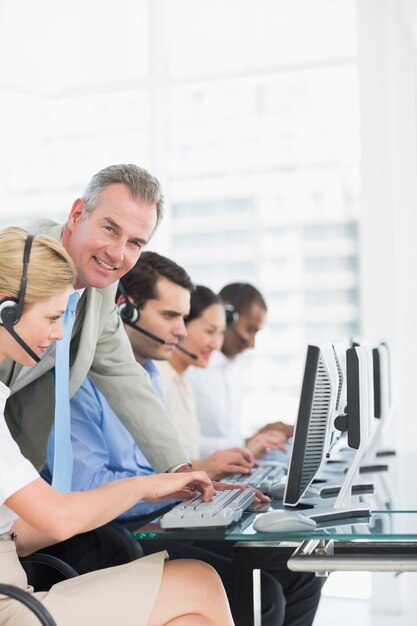 Premium Photo | Manager and executives with headsets using computers