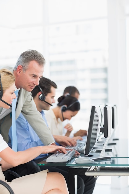 Premium Photo | Manager and executives with headsets using computers