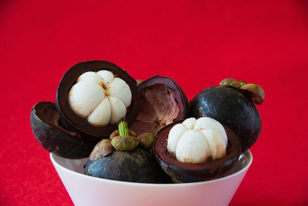 マンゴスチンタイの人気のある果物 厚い赤茶色の皮の中に肉の甘いジューシーな白いセグメントを持つトロピカルフルーツ 無料の写真