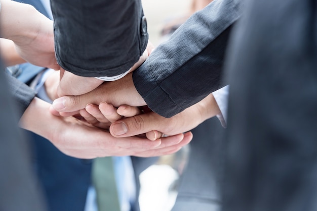 people joining hands together