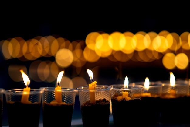 Premium Photo | Many candles burning for spirit meditation