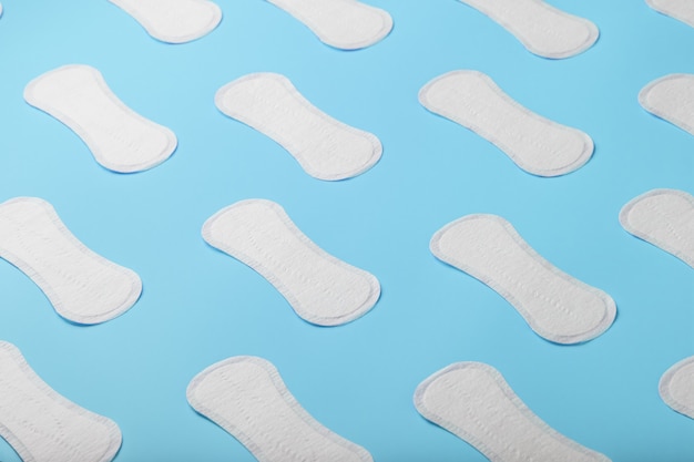 Premium Photo | Many sanitary pads on a blue background in the form of ...