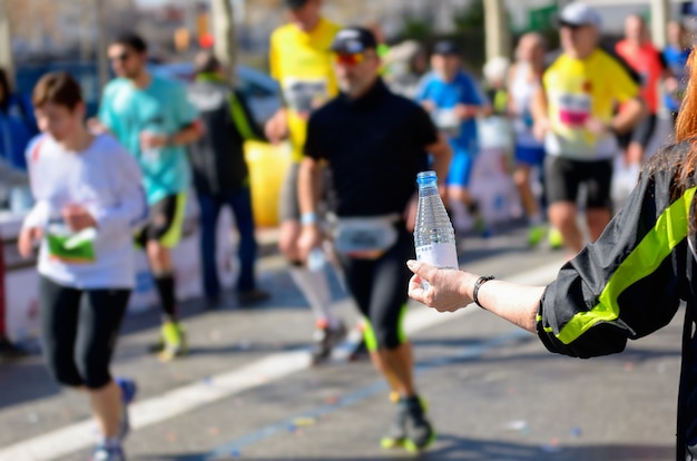 Premium Photo | Marathon running race, runners on road, volunteer ...