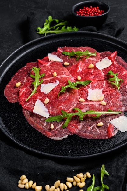 Premium Photo | Marbled beef carpaccio with arugula and parmesan cheese