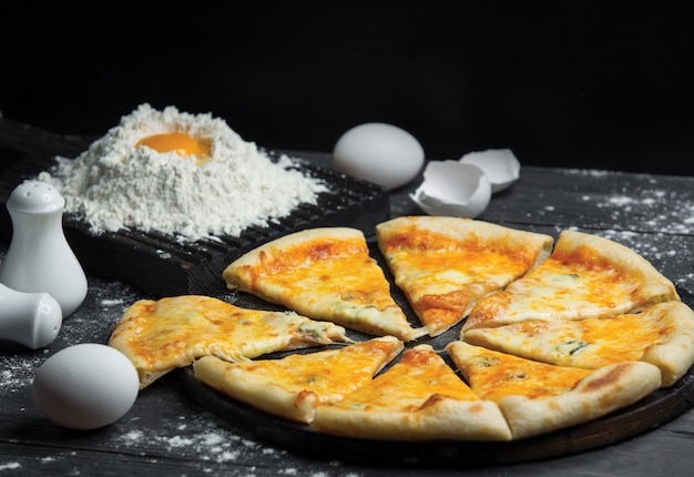 Margarita pizza cut into slices and dough making Free Photo