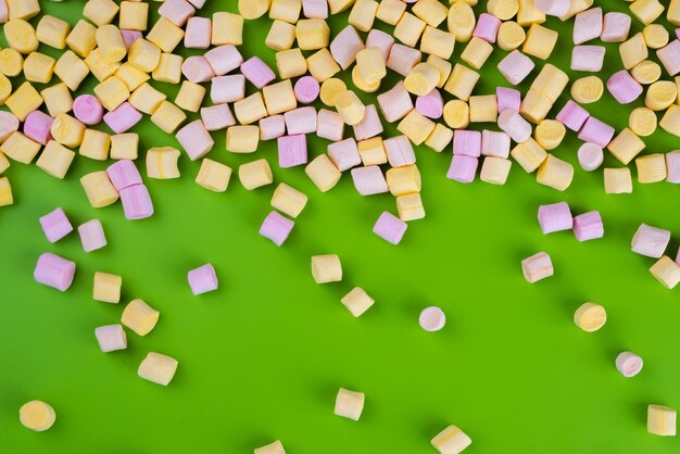 Premium Photo | Marshmallows on green background with copyspace. flat ...