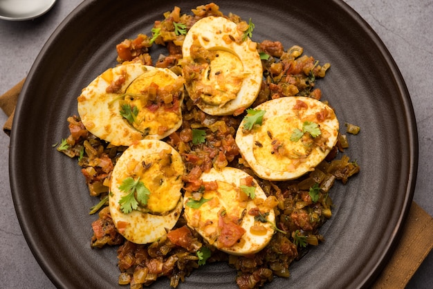 Premium Photo Masala Egg Tawa Fry Or Ande Ki Sabzi Served In A Plate