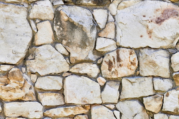 組積造の岩壁のテクスチャ 古い城の基礎の石 デザインやイラストの石の壁の背景 プレミアム写真