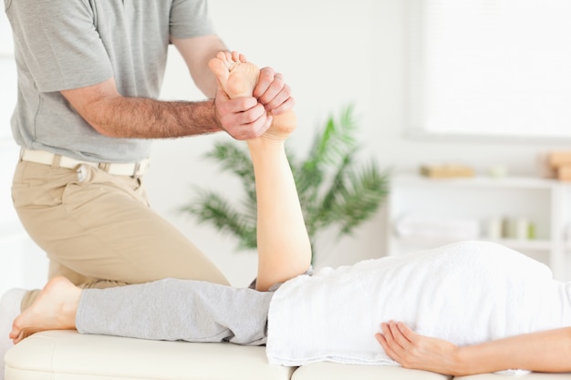 Premium Photo | Masseur massaging a customer's foot