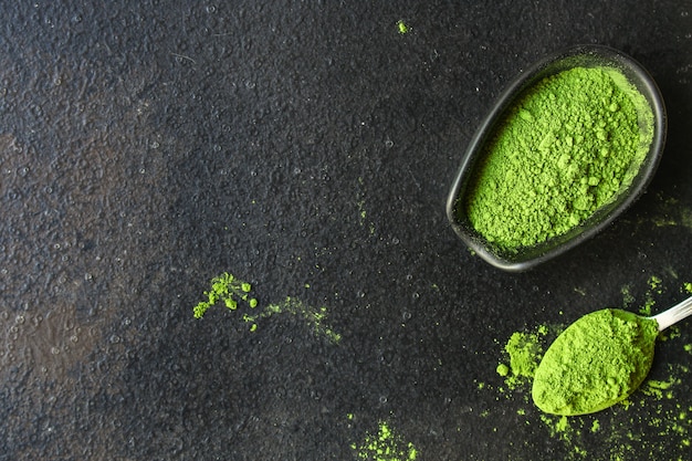 Premium Photo | Matcha - green tea powder, food supplement, dark background