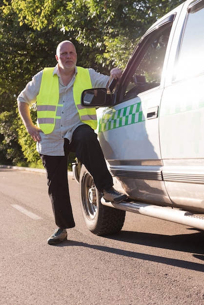 Premium Photo | A mature man standing next to his pickup truck