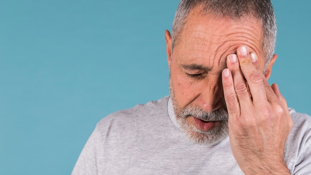 Mature man suffering from headache Free Photo