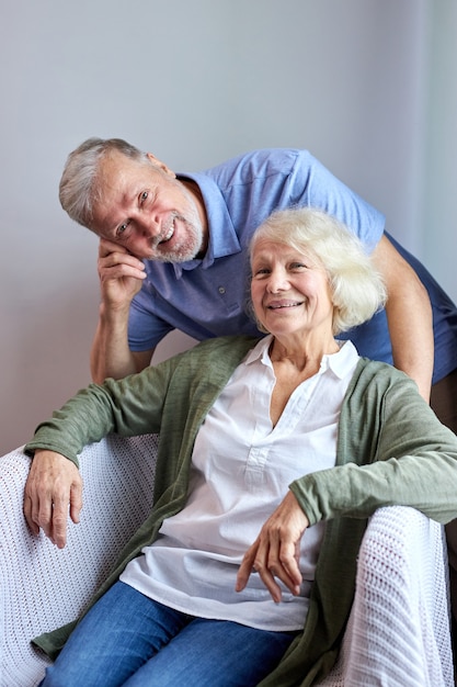 Mature wife com Premium Photo Mature Wife And Husband Posing At Camera Smiling On Cozy Couch At Home Woman Sitting While Her Husband Stand Behind Her Portrait