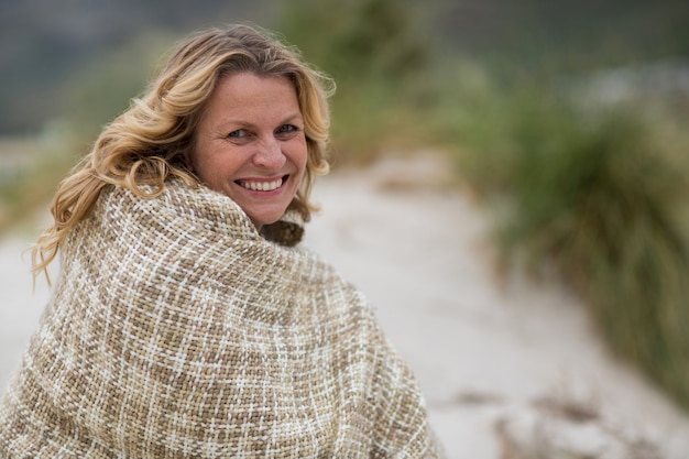 Premium Photo Mature Woman Wrapped In Shawl On The Beach