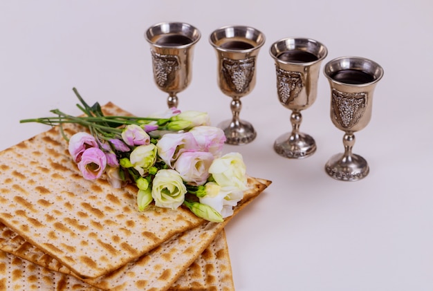 Premium Photo | Matzah and four cups full of wine