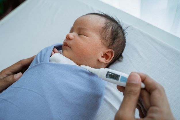 premium-photo-measuring-temperature-to-baby