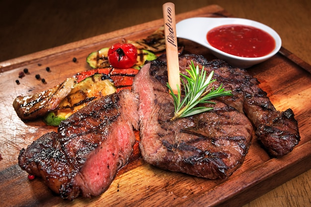 Premium Photo | Meat steak on a wooden board