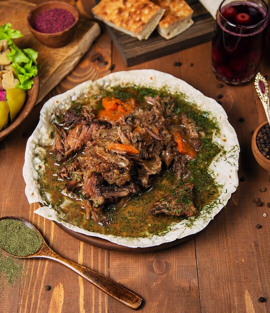 Free Photo | Meat stew, turshu govurma with onions, green herbs ...