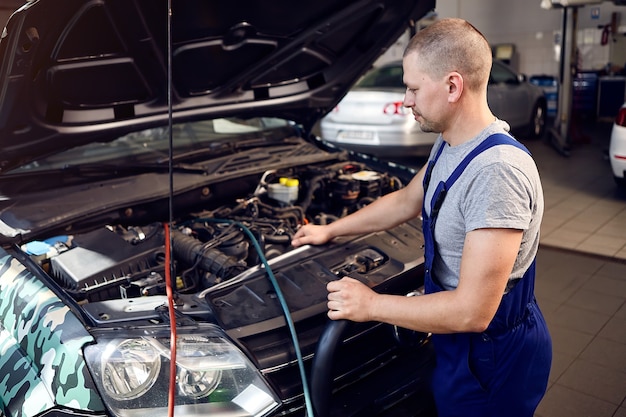 Premium Photo | Mechanic checks air conditioning system in car auto service