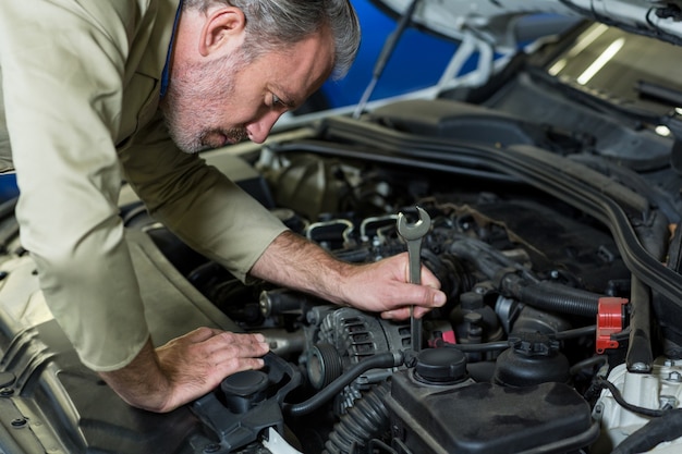 Free Photo | Mechanic servicing a car engine