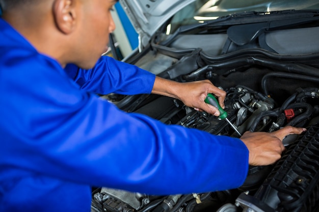 Free Photo | Mechanic servicing a car engine