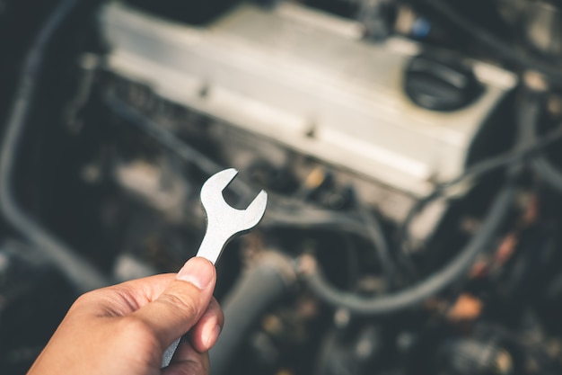 Mechanical engineer hands open the car skirt to check the oil level of the car Premium Photo