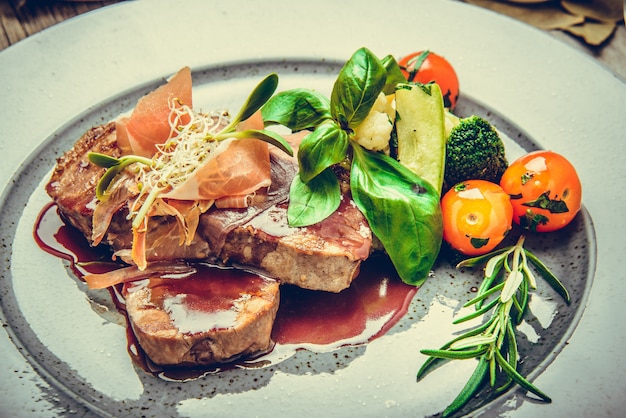 Premium Photo | Medallions of veal, with sauce on a plate