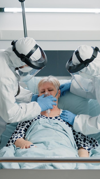 Premium Photo | Medical team with suits and masks helping heavy ...