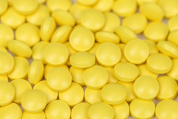 Premium Photo | Medicine background of yellow painkillers