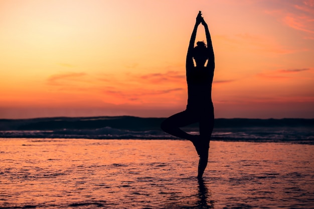 Download Meditation yoga silhouette of woman on the sea beach at ...