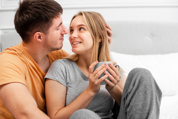 Free Photo | Medium shot happy couple with coffee in bed