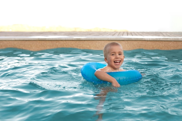 Premium Photo | Medium shot kid with blue lifebuoy