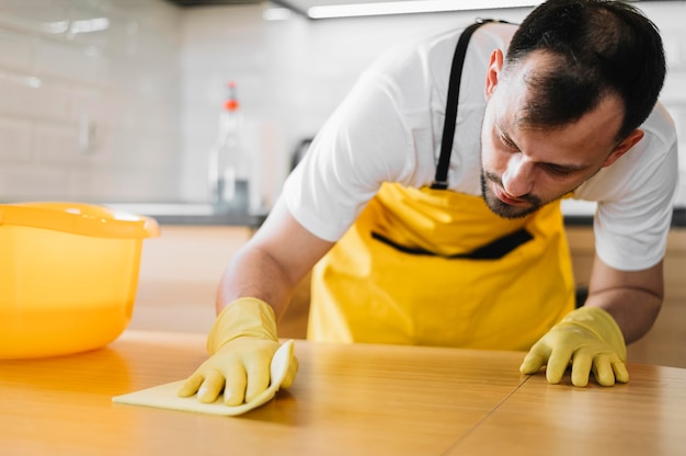 Free Photo | Medium shot man cleaning table