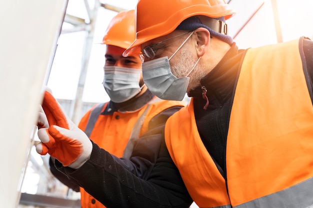 Premium Photo | Medium shot men wearing masks