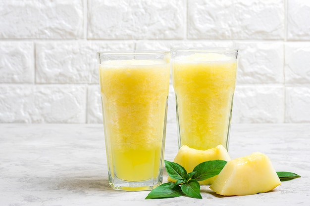 Premium Photo Melon Lemonade Smoothie With Ice And Basil In A Glass On The Gray Table Summer Refreshing And Detox Drink Rustic Style