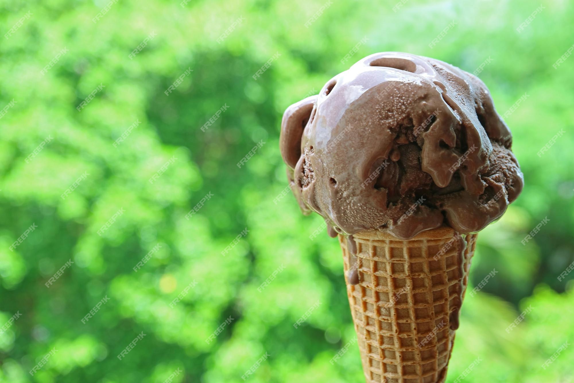 premium-photo-melting-chocolate-ice-cream-in-cone-isolated-on-blurry-summer-garden