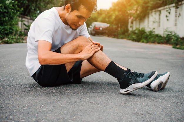 Premium Photo | Men with knee pain while jogging