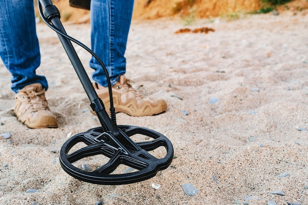 Premium Photo | Metal detector coil in action above the ground