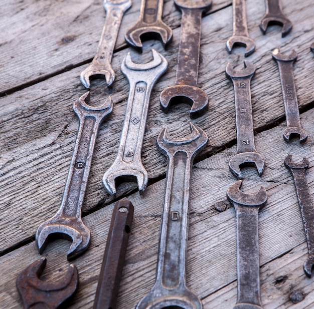 Premium Photo | Metal wrench rusty tools lying on a black wooden table ...