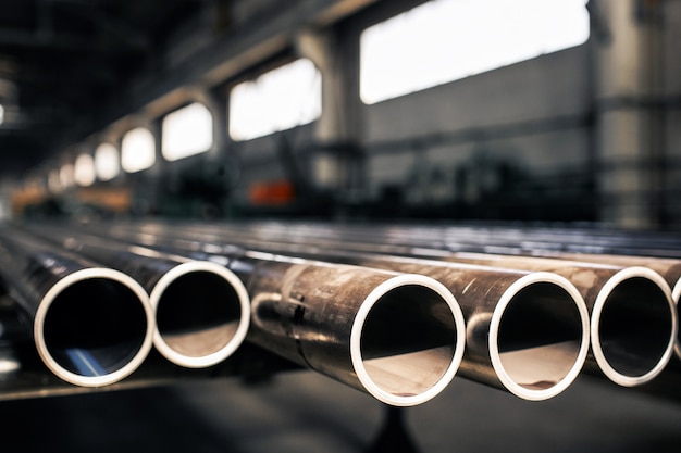 Metallic pipes on warehouse, rows of metal pipes on industrial warehouse. Premium Photo