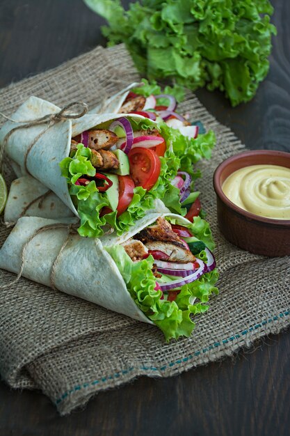 mexican-dish-taco-with-chicken-and-vegetables-close-up-on-a-wooden