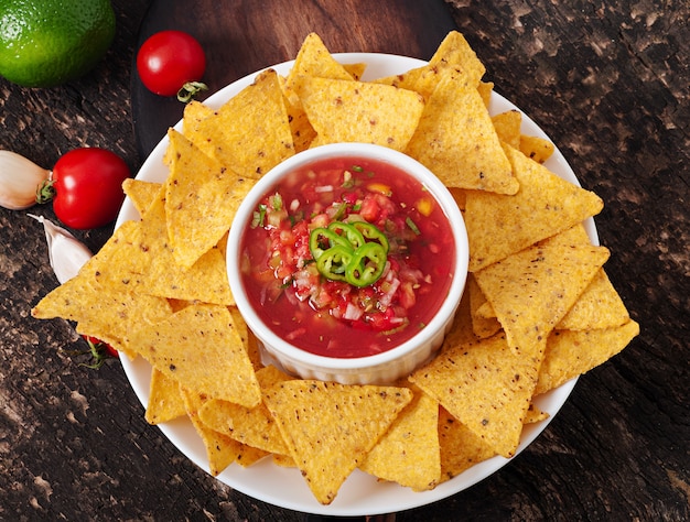 Mexican nacho chips and salsa dip in bowl | Free Photo