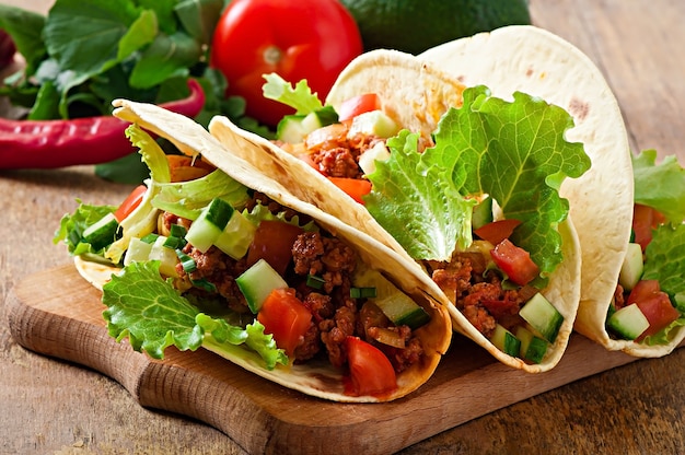 Mexican tacos with meat, vegetables and cheese Free Photo