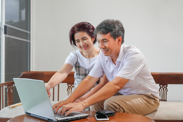 Premium Photo | Middle aged asian couple work from home
