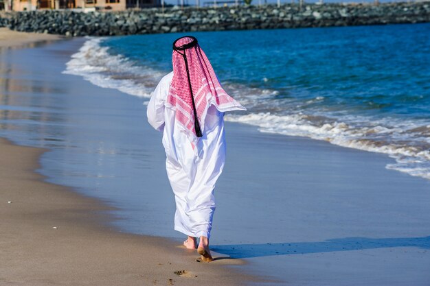 Premium Photo | Middle eastern way dressed arab man poses in front of ...