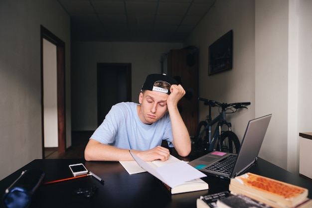 Premium Photo The Midwife Fell Asleep At The Table In His Room While Studying At Home Homework