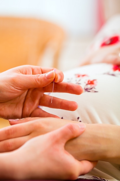 Premium Photo | Midwife giving pregnancy acupuncture