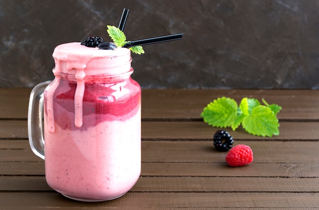 Premium Photo | Milk shake in a jar on wooden background.