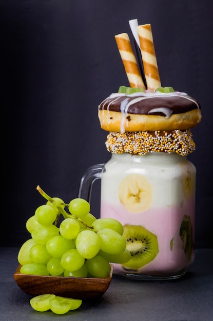 Premium Photo | Milkshake (cocktail) with kiwi and banana in glass with ...